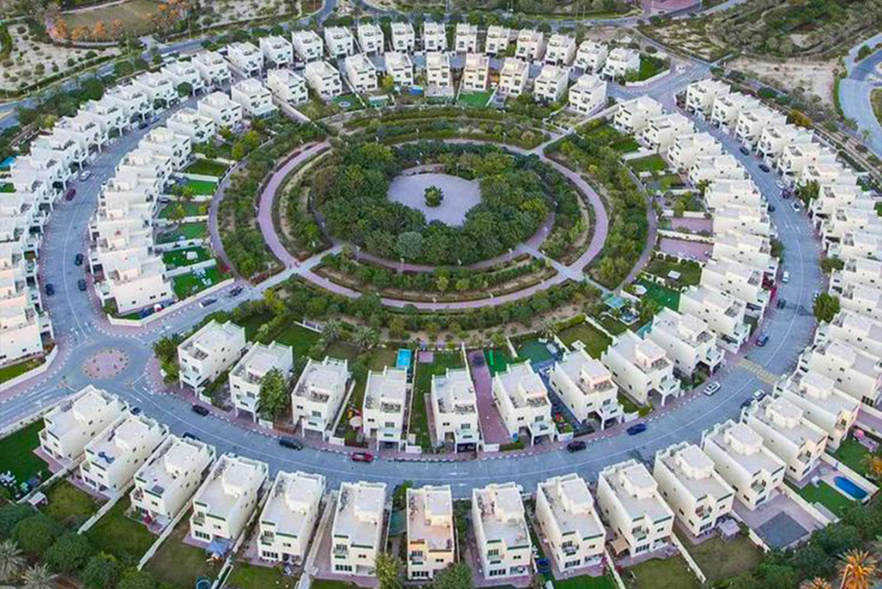 Lush green community park in Jumeirah Village Circle (JVC), Dubai, near Heritage Development properties.